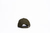 Green cap with black rub badge